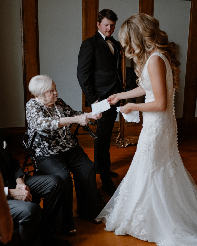 bride giving her grandmother a replica of a generations old handkerchief.