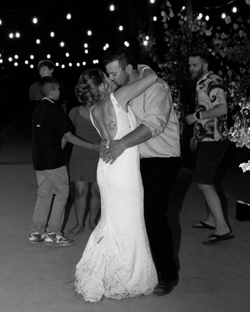 bride and groom on the dance floor kissing.
