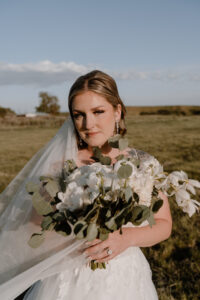 bride holding her boutique looking beautiful in the golden sunlight.