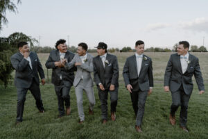 groom and groomsmen walking and talking.