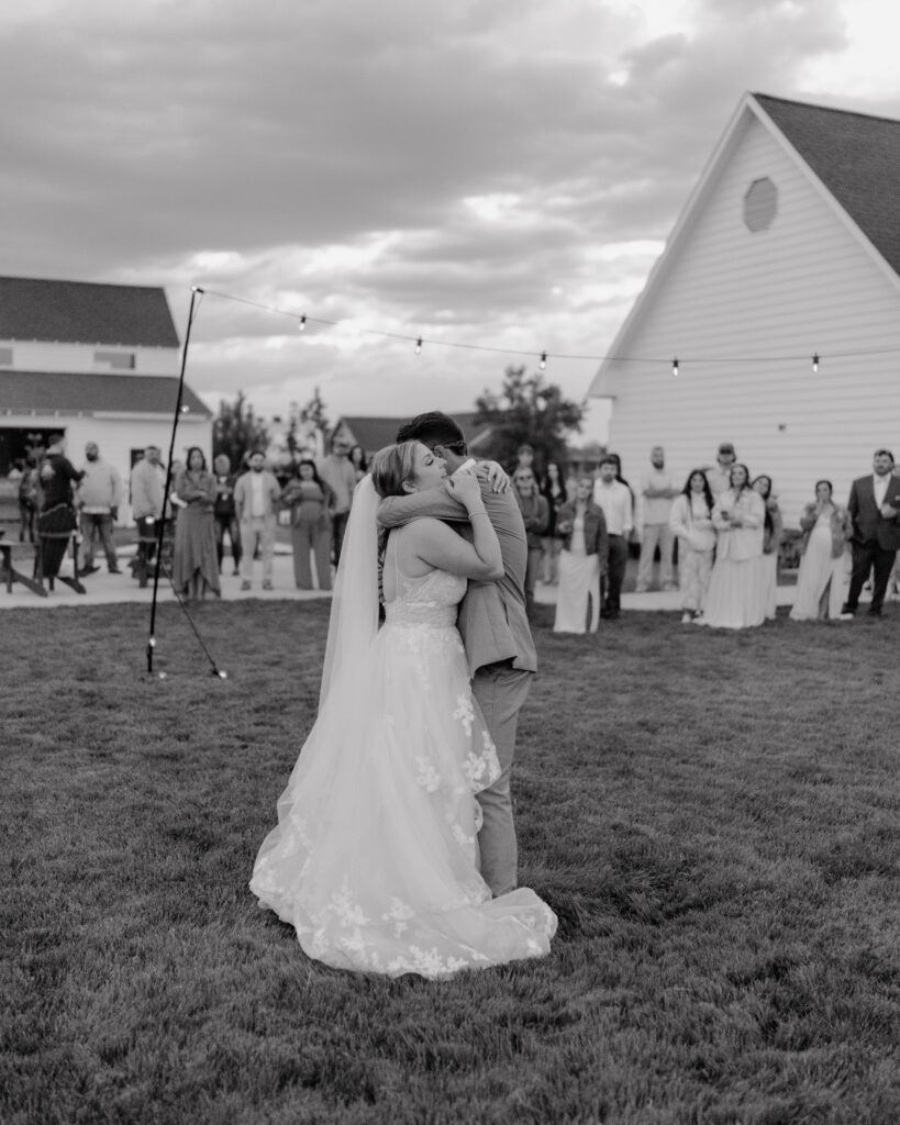 bride and groom hugging on the dance floor during their first dance at their farmhouse wedding in Walla Walla, WA.