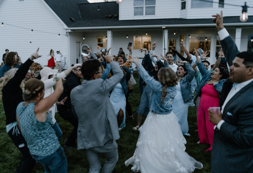 bride and groom dancing with all their guests at the reception.