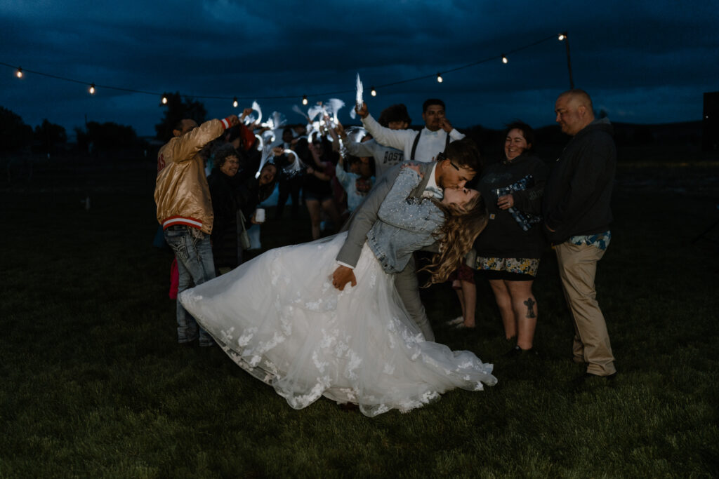 bride and groom kissing during their grand exist at their farm house wedding in Walla Walla.