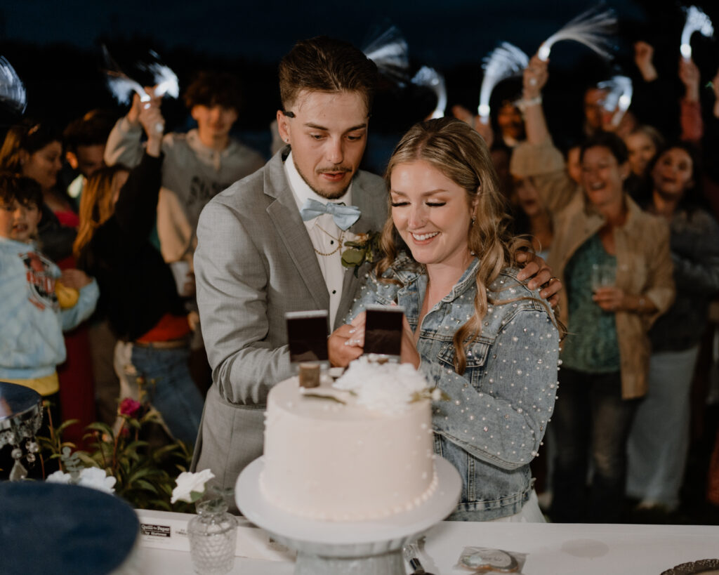 bride and groom cutting the cake.