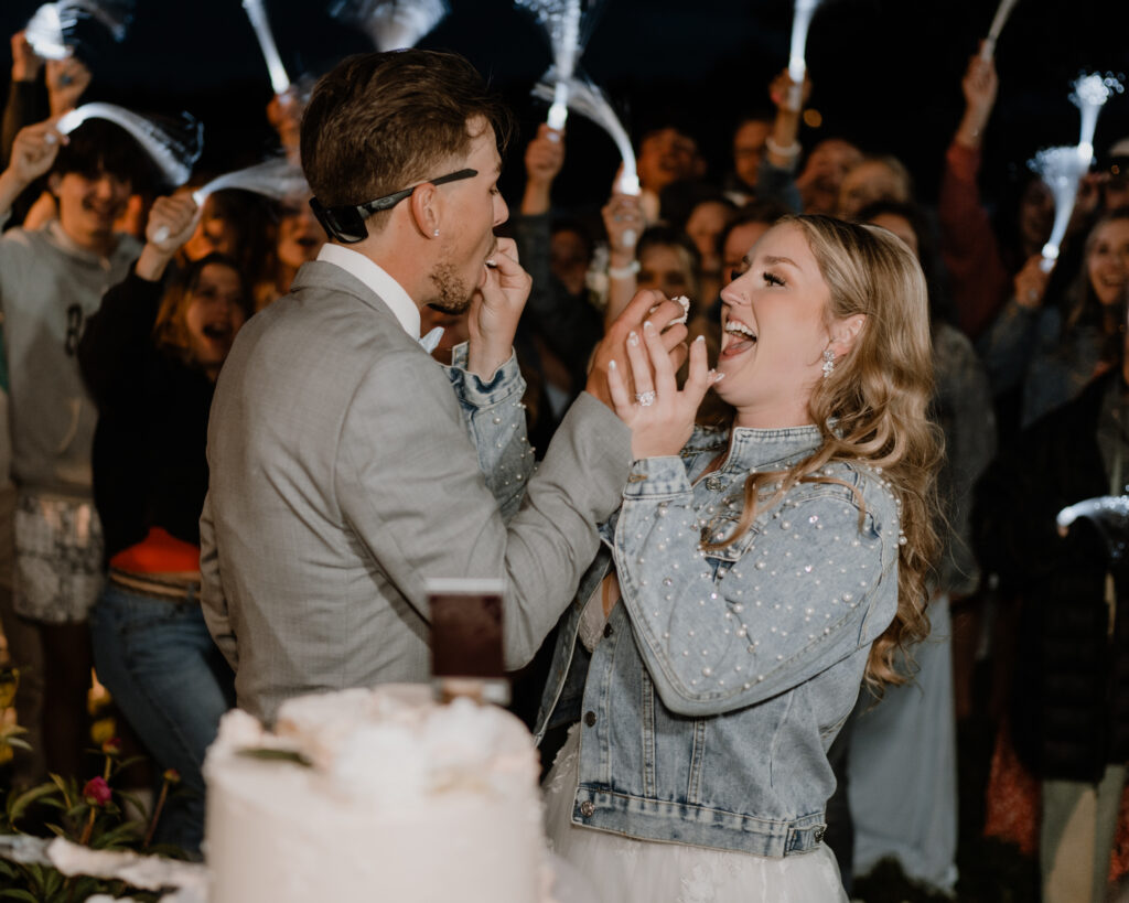 bride and groom feeding each other cake.