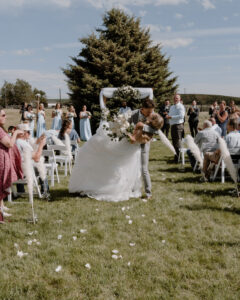 bride and groom kissing at the end of the aisle.