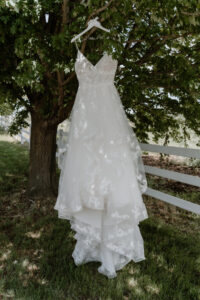 detail of bride's dress hanging in the trees at the Farmhouse wedding in Walla Walla, WA. 