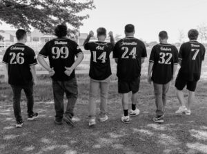 groom and groomsmen standing in custom jerseys.  