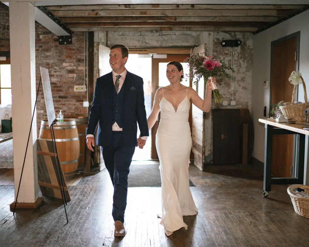 bride and groom entering the reception of their documentary wedding at Overbluff Cellars.