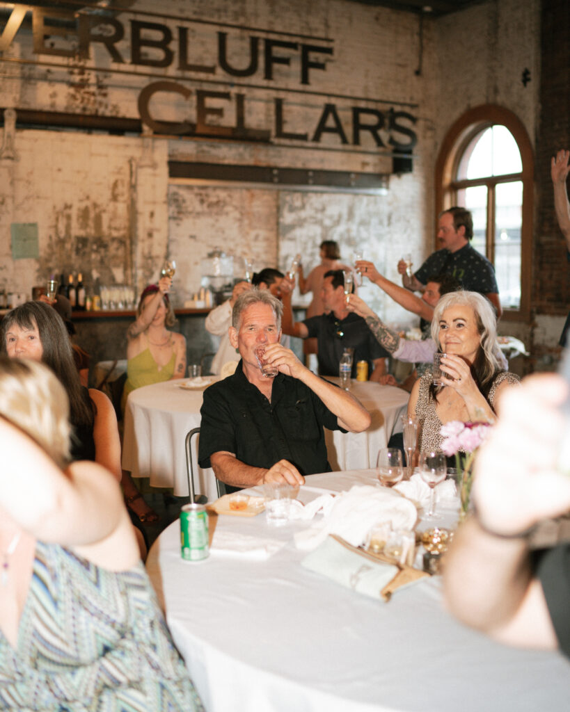 guests cheering and toasting during speeches at Overbluff Cellars.