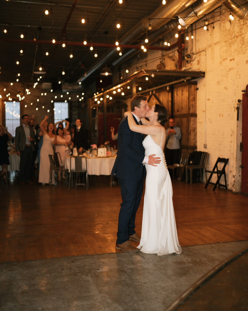 bride and groom kissing during their first dance.