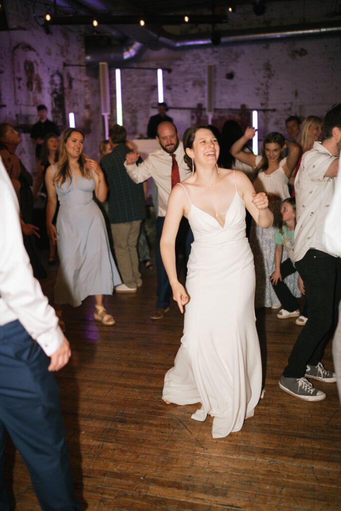 bride dancing during the reception at her documentary wedding.