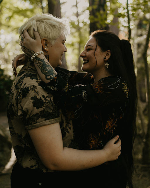 couples embracing and smiling during their engagement photos at Manito Park in Spokane, WA.