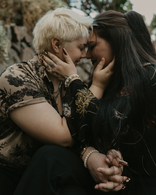 couples holding each others face as they touch foreheads for their Fall engagement session. 