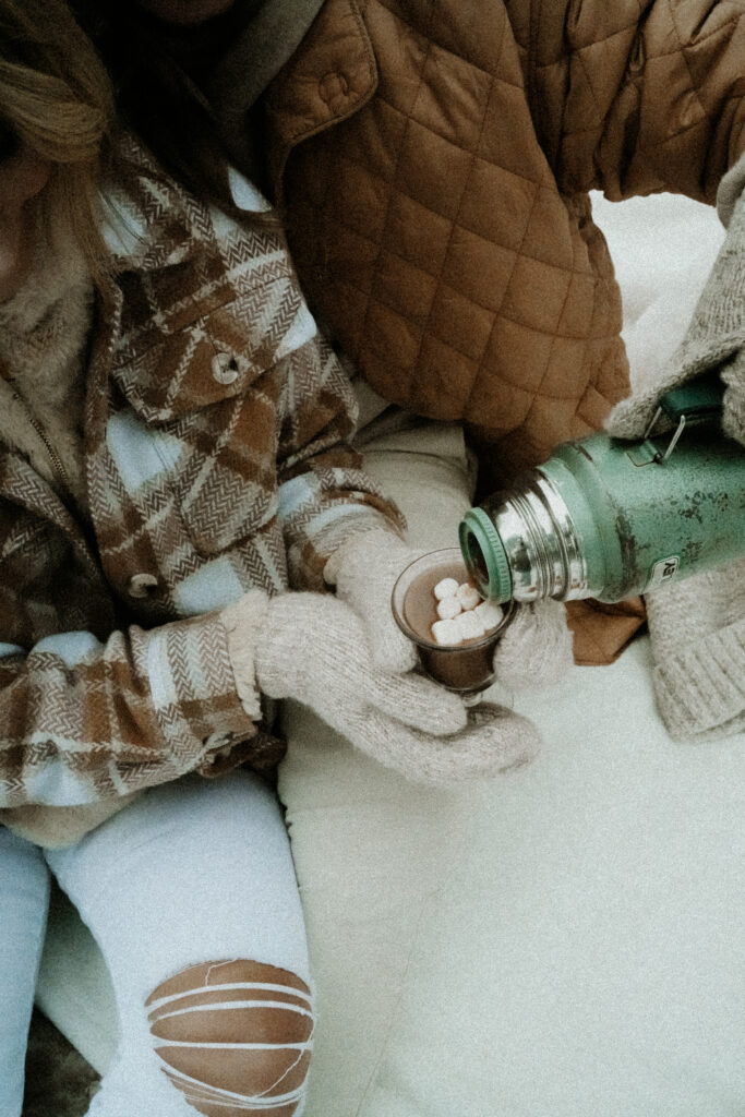 couple pouring hot cocoa. 