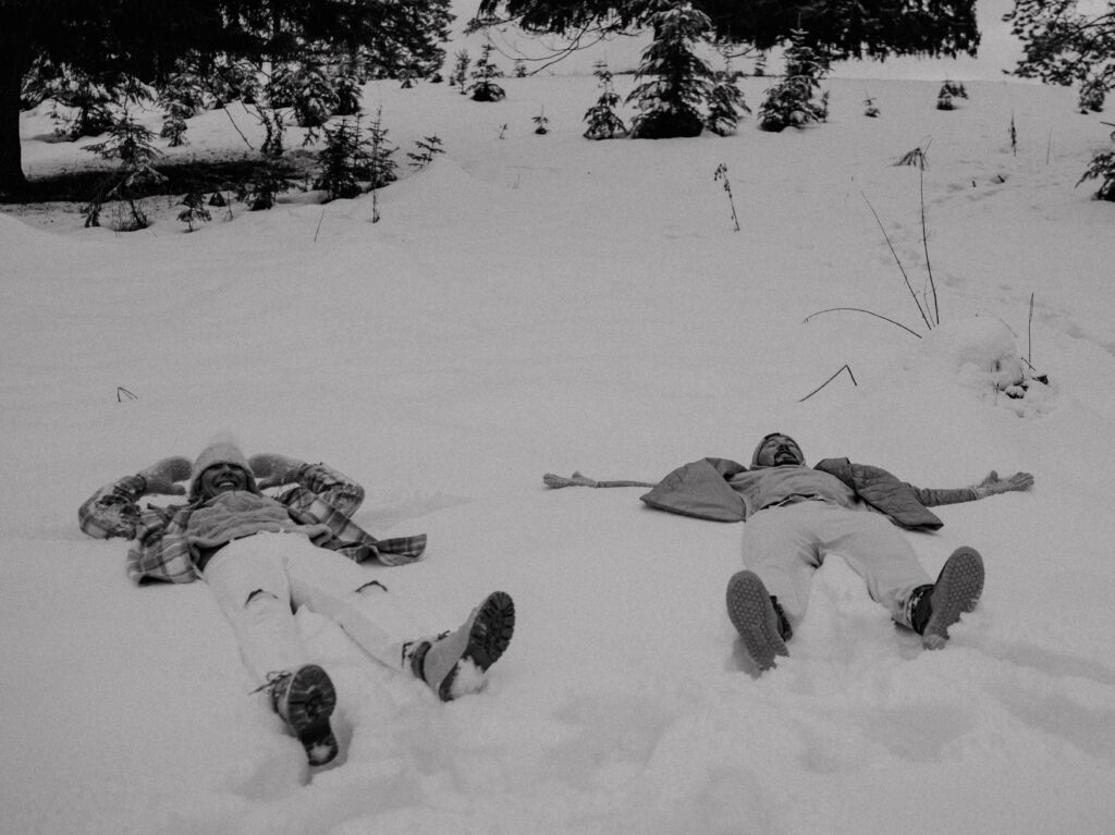 couple making snow angles. 