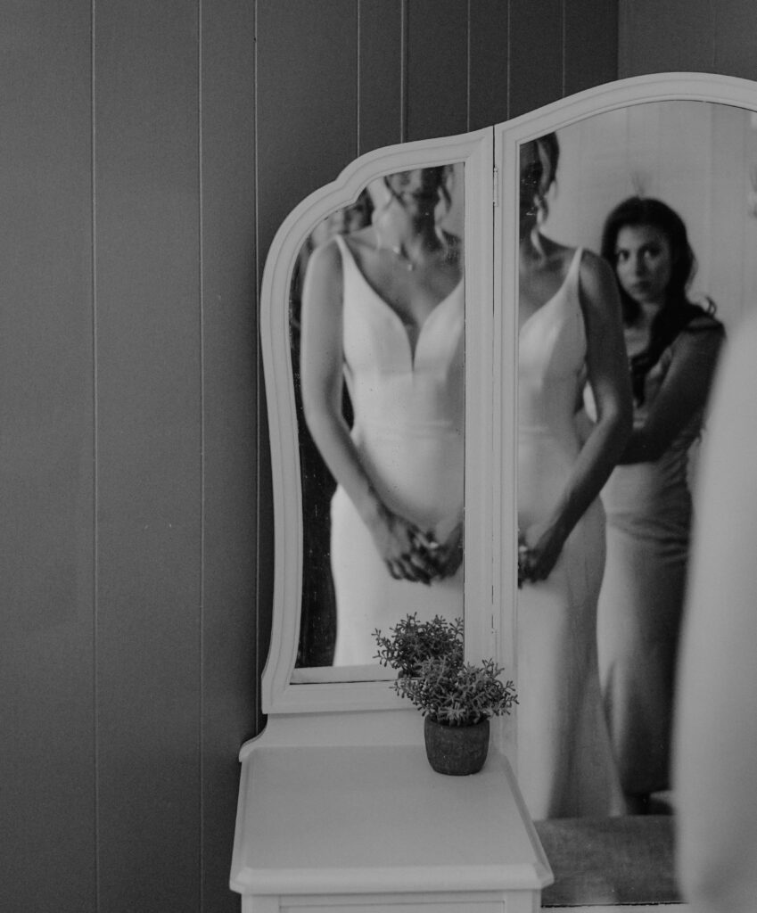 bride getting ready with her bridesmaid