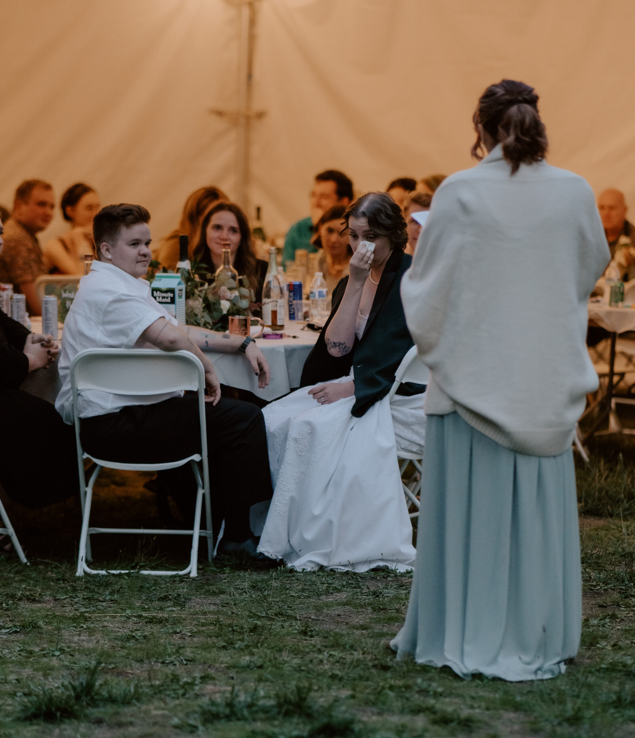 grooms sister saving time on photos by giving her speech during dinner.  
