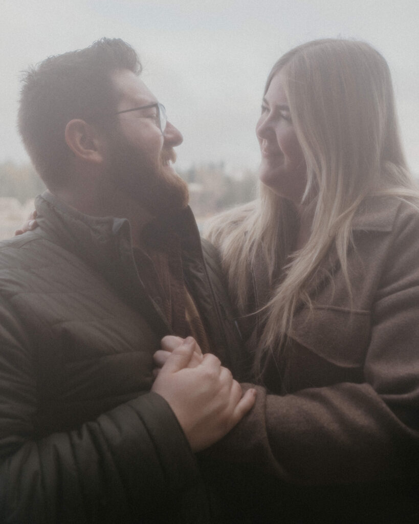 couple holding hands and looking at each other.