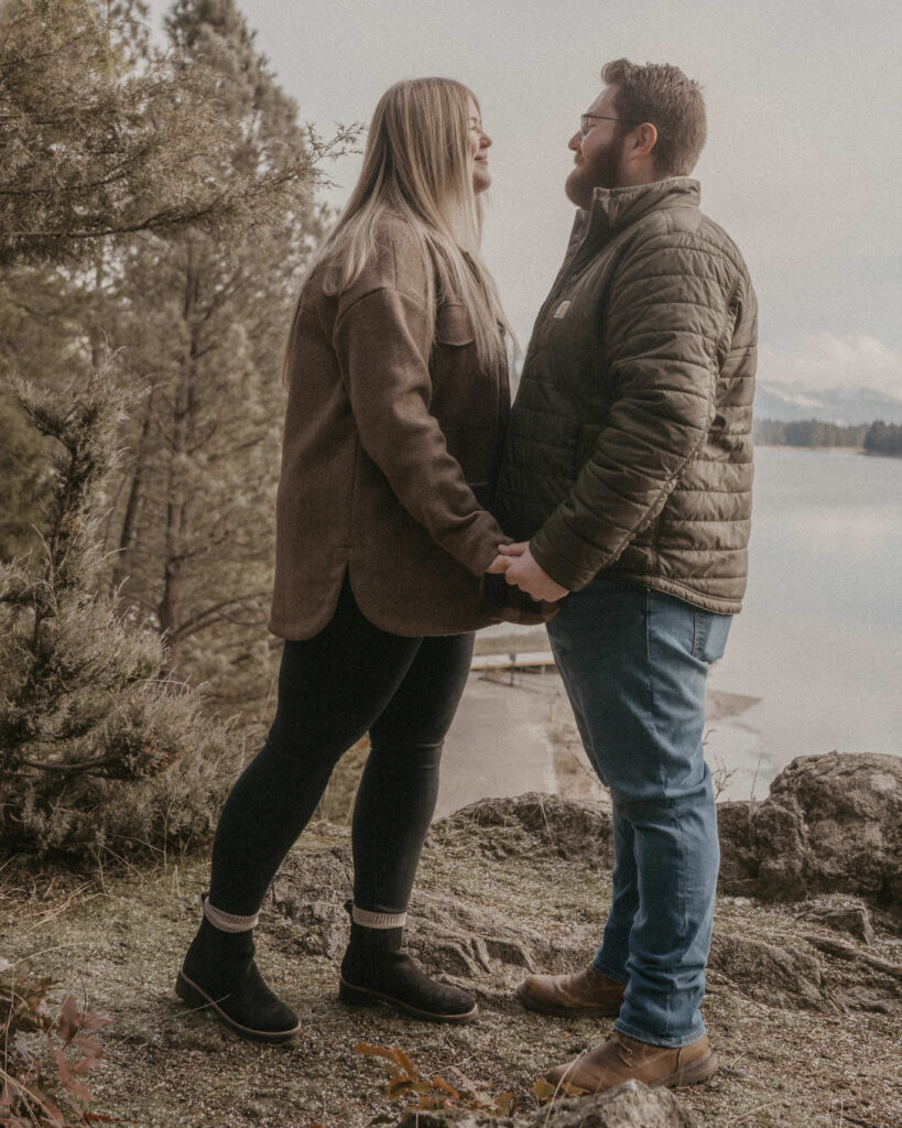 Idaho Winter Couples Session with the couple holing hands and looking at each other,