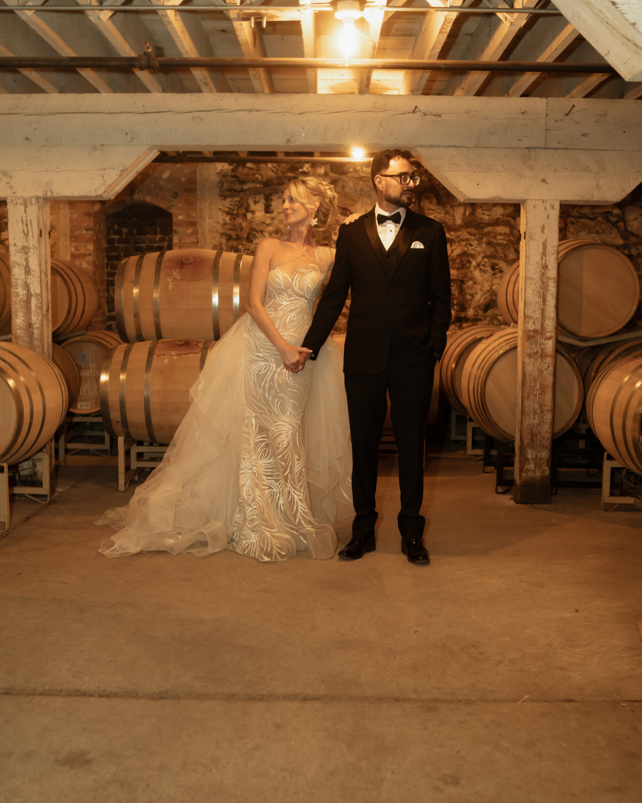 bride and groom posing Hollywood style in the wine cellar at Barrister Winery in Spokane, WA