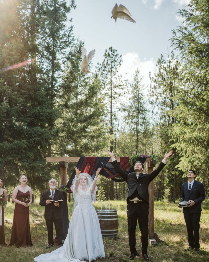 Bride and groom releasing doves at their ceremony