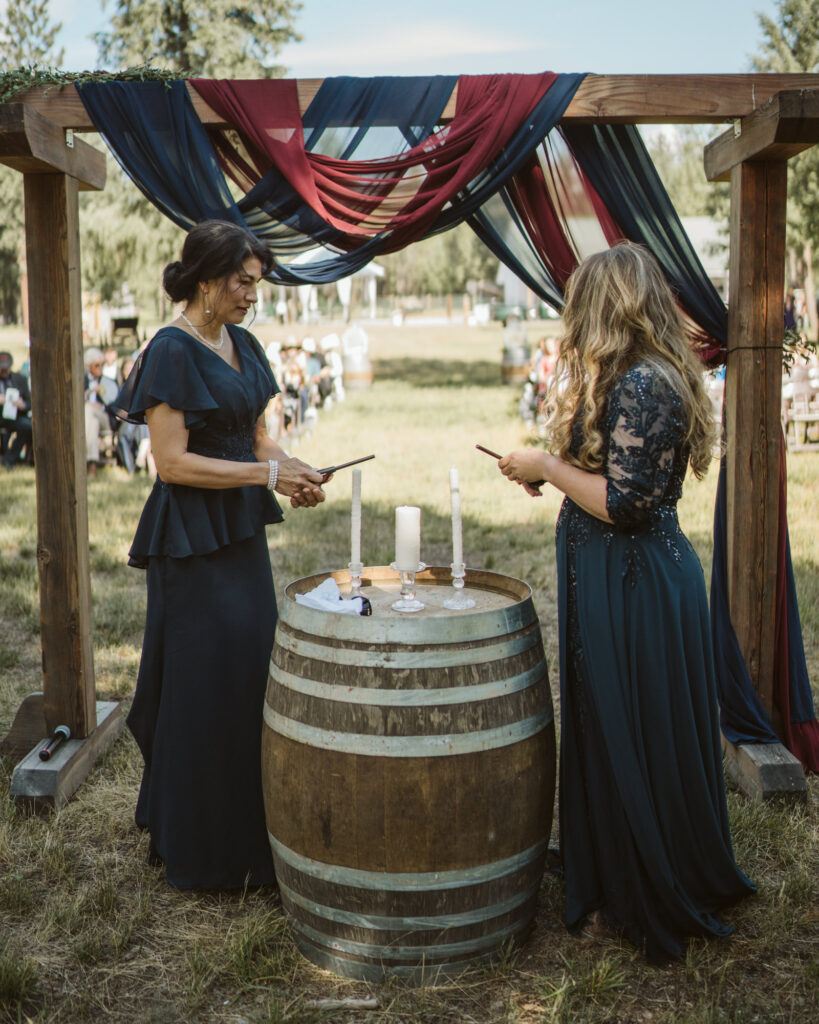 bride and groom's mother's lighting the candles for the unity candle