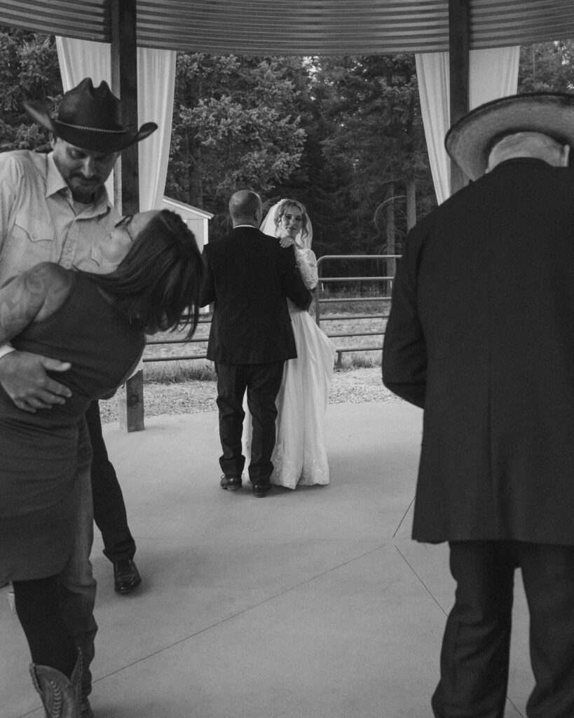 Bride dancing with her dad as other couples start to come onto the dance floor to join in. 