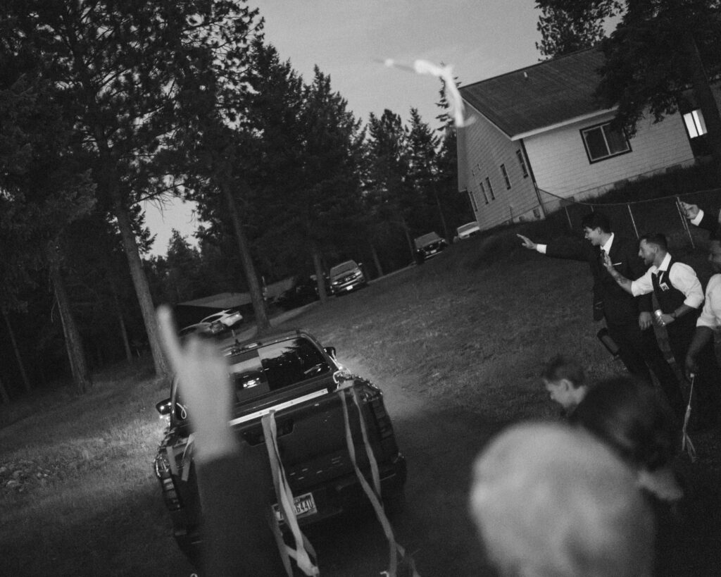 candid moment of the get a way truck and guests with a ribbon wand flying in mid air.